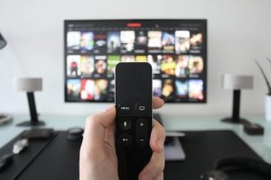 A hand holding a remote control